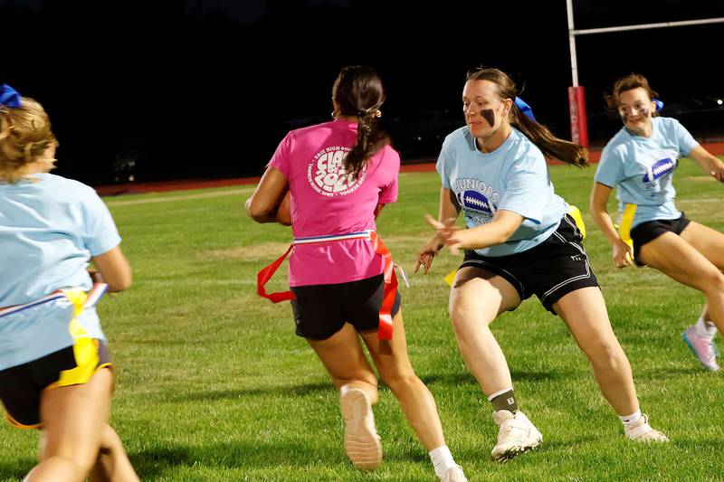 Junior Aiden Klendworth (blue) tries to stop her competitor, senior Ashlyn Johnson during the championship game of the annual EHS Powder Puff tournament Wednesday, Oct. 1, 2025, in Erie. Each year during homecoming week the girls take to the field to see which class will come out on top. This year the Seniors got the bragging rights and the trophy.
