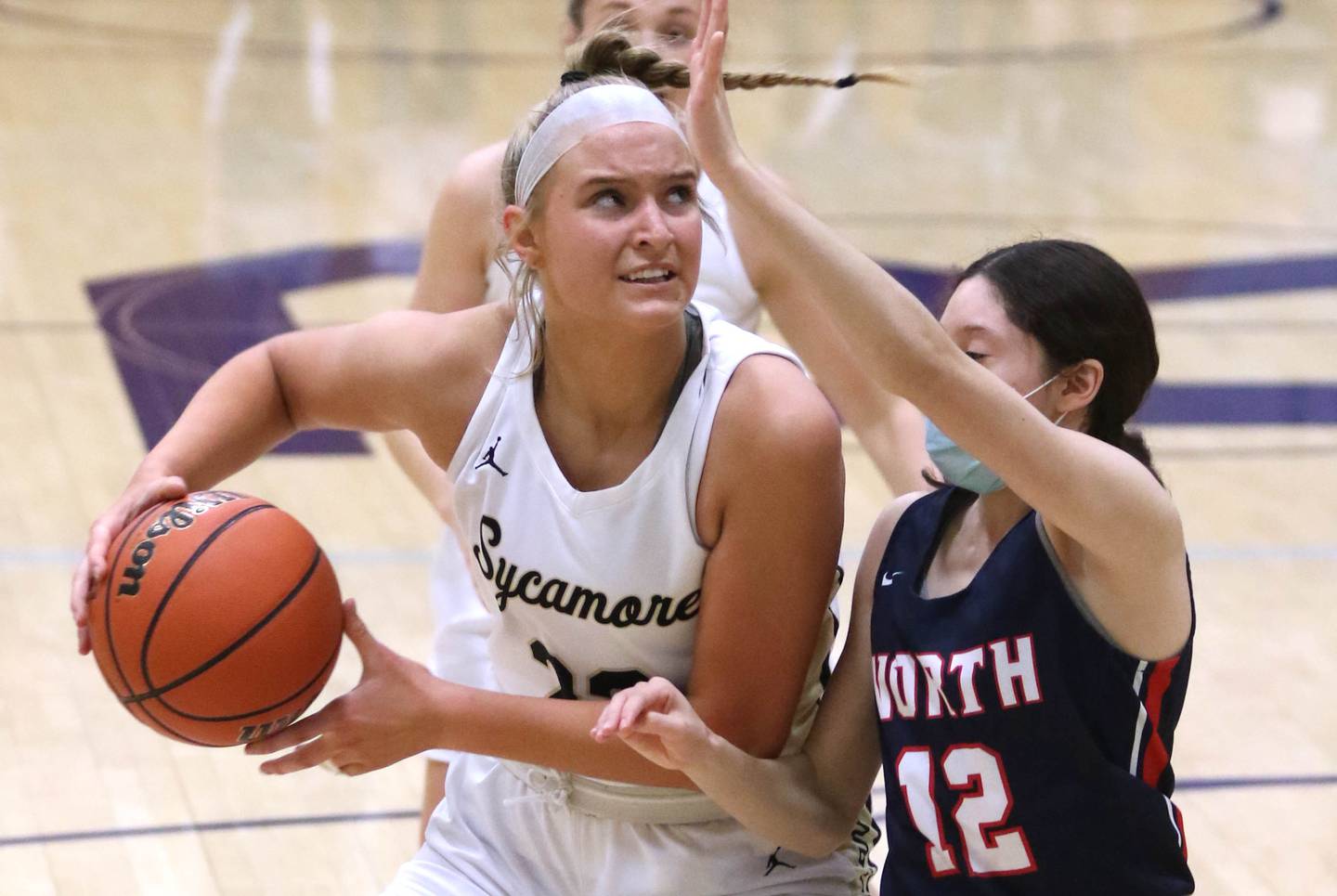 Sycamore's Evyn Carrier posts up Belvidere North's Josy Ostalaza during their IHSA regional final game Thursday, Feb. 17, 2022, at Rochelle High School.
