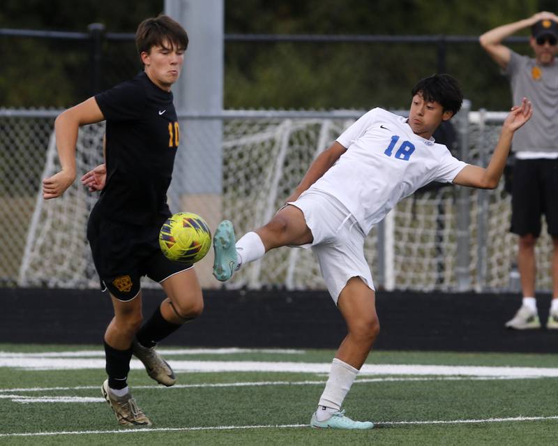 Woodstock's Diego Najera Mercado kicks the ball away from Richmond-Burton’s Nick Kyes during a Kishwaukee River Conference soccer match on Wednesday, Sept. 10, 2025, at Richmond-Burton High School, in Richmond.