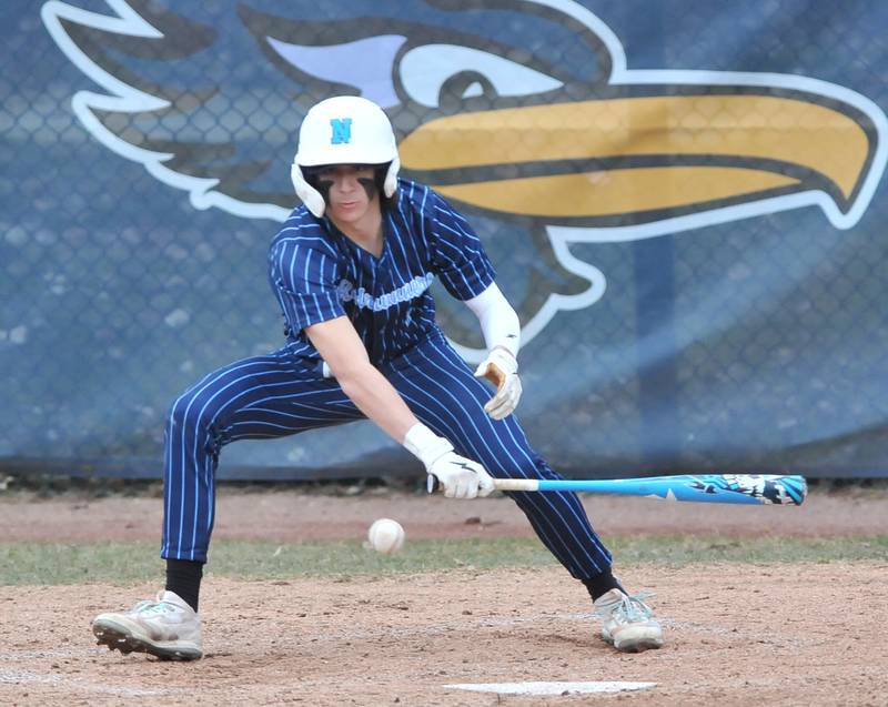 Nazareth's Luca Fiore bunts for a single that also advanced the runner on base during a game against Benet Academy on Apr. 12, 2022 at Nazareth Academy in LaGrange Park.