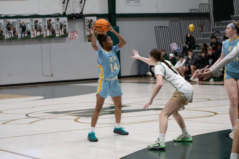 Joliet Catholic's Laylah Carroll looks to pass during their game against Bishop McNamara on Wednesday, Feb. 11, 2026.