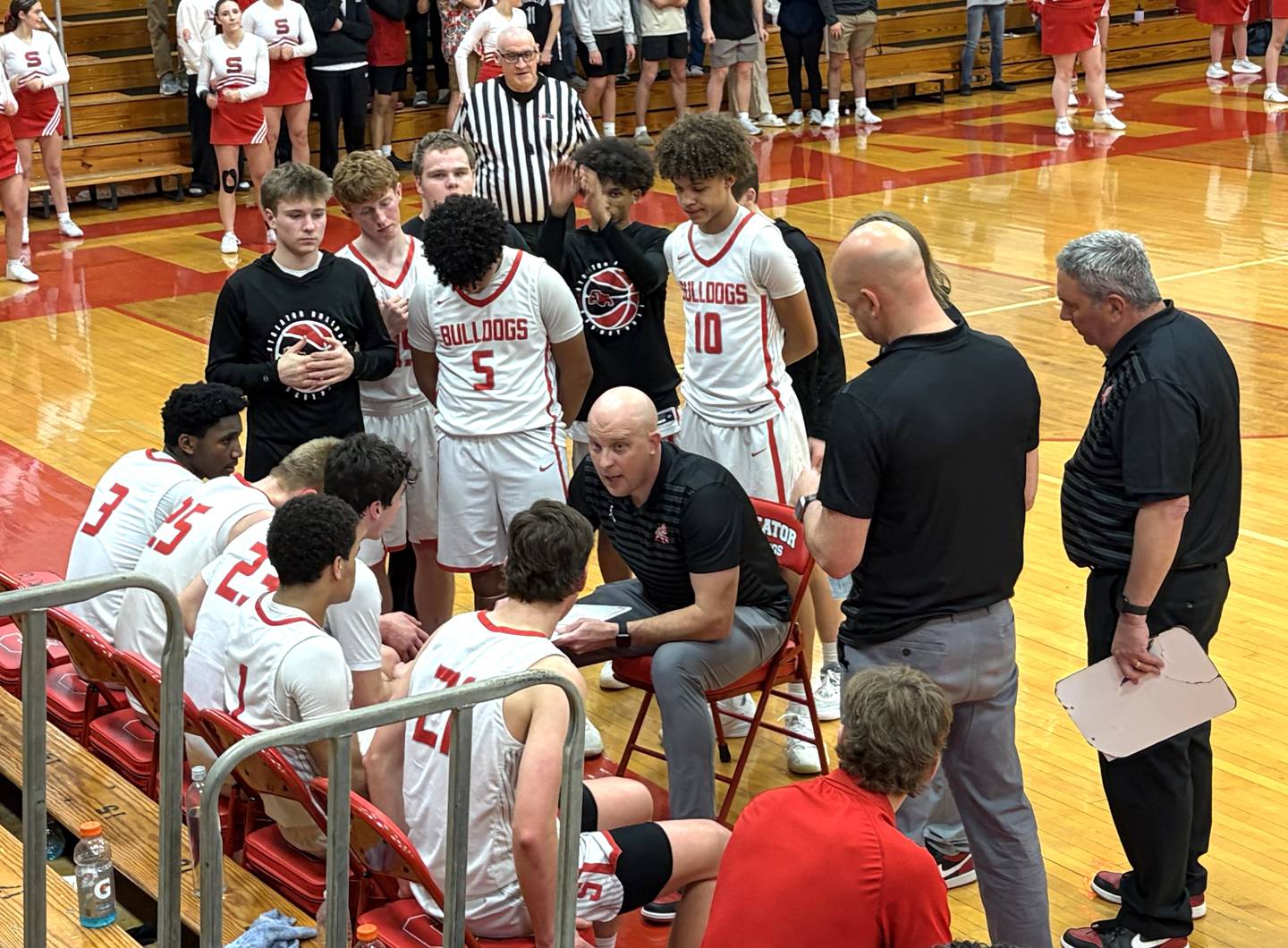 Streator boys basketball coach Beau Doty (center) discusses strategy with his Bulldogs on Tuesday, Feb. 17, 2026, at Pops Dale Gymnasium.