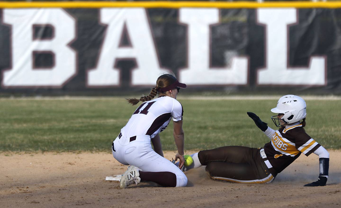 Jacobs' Emily Popilek (right) slides into second base as Prairie Ridge’s Kylie Carroll tries to tag her during a Fox Valley Conference game on April 8, 2026, at Prairie Ridge High School.