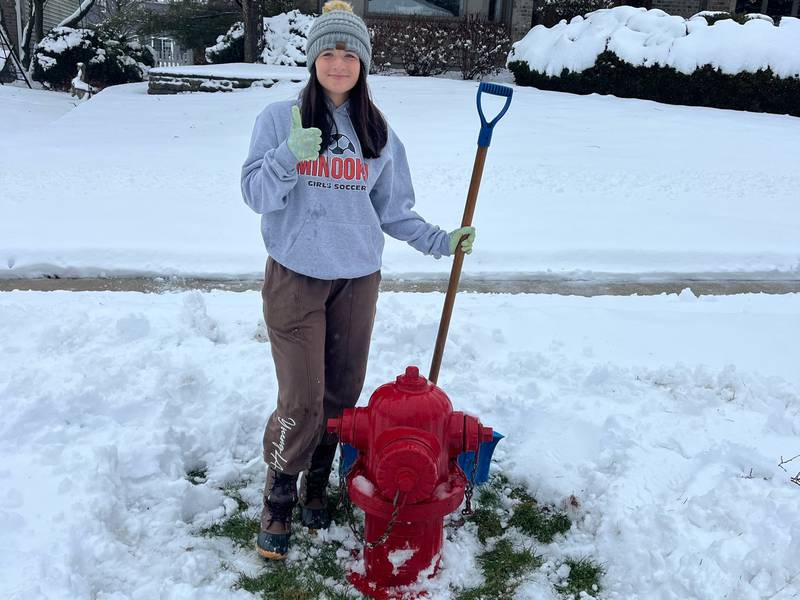 Minooka High School student Sophia Rausa clears the fire hydrant near her house.