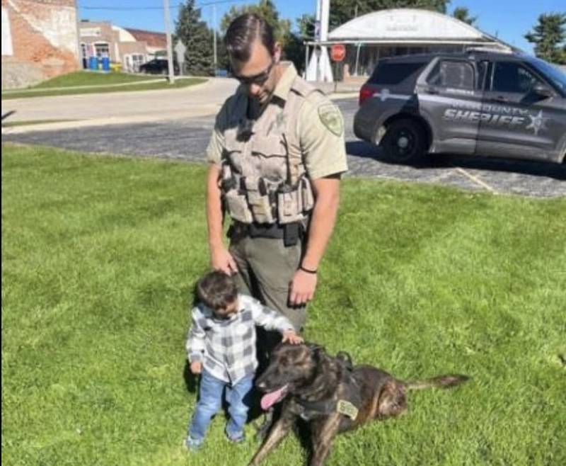 Lee County Deputy Nathan Hollinger and K-9 Nemo pose with an unidentified youngster.