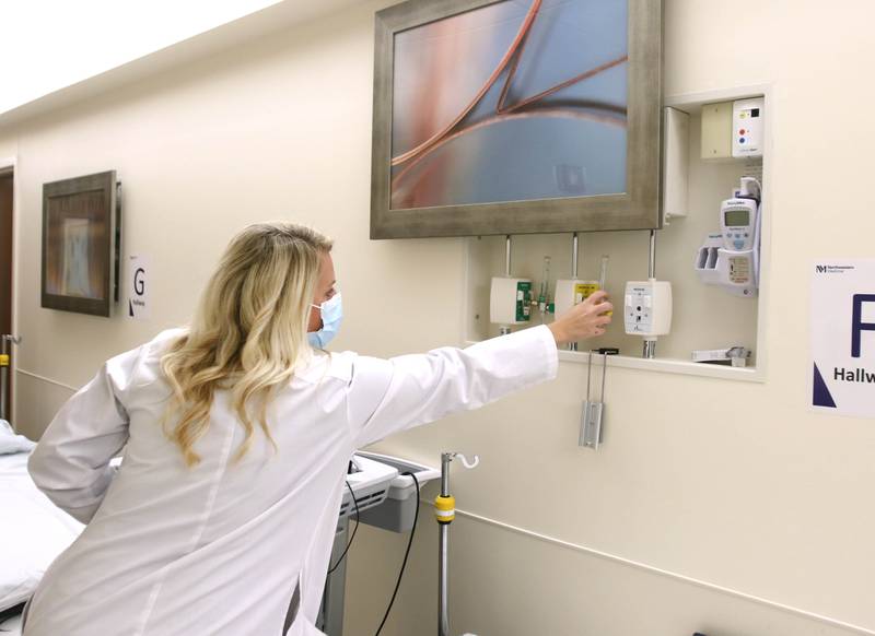 Kristen Tindall, emergency department manager at Northwestern Medicine Kishwaukee Hospital, talks Wednesday, Oct. 20, 2021, about the hall beds that can be used in an overflow situation and the equipment that is hidden by paintings until access is needed, during a tour of the recently opened phase 1 at the facility. The full $12 million renovation of the emergency department is expected to be completed in Sept. 2022.