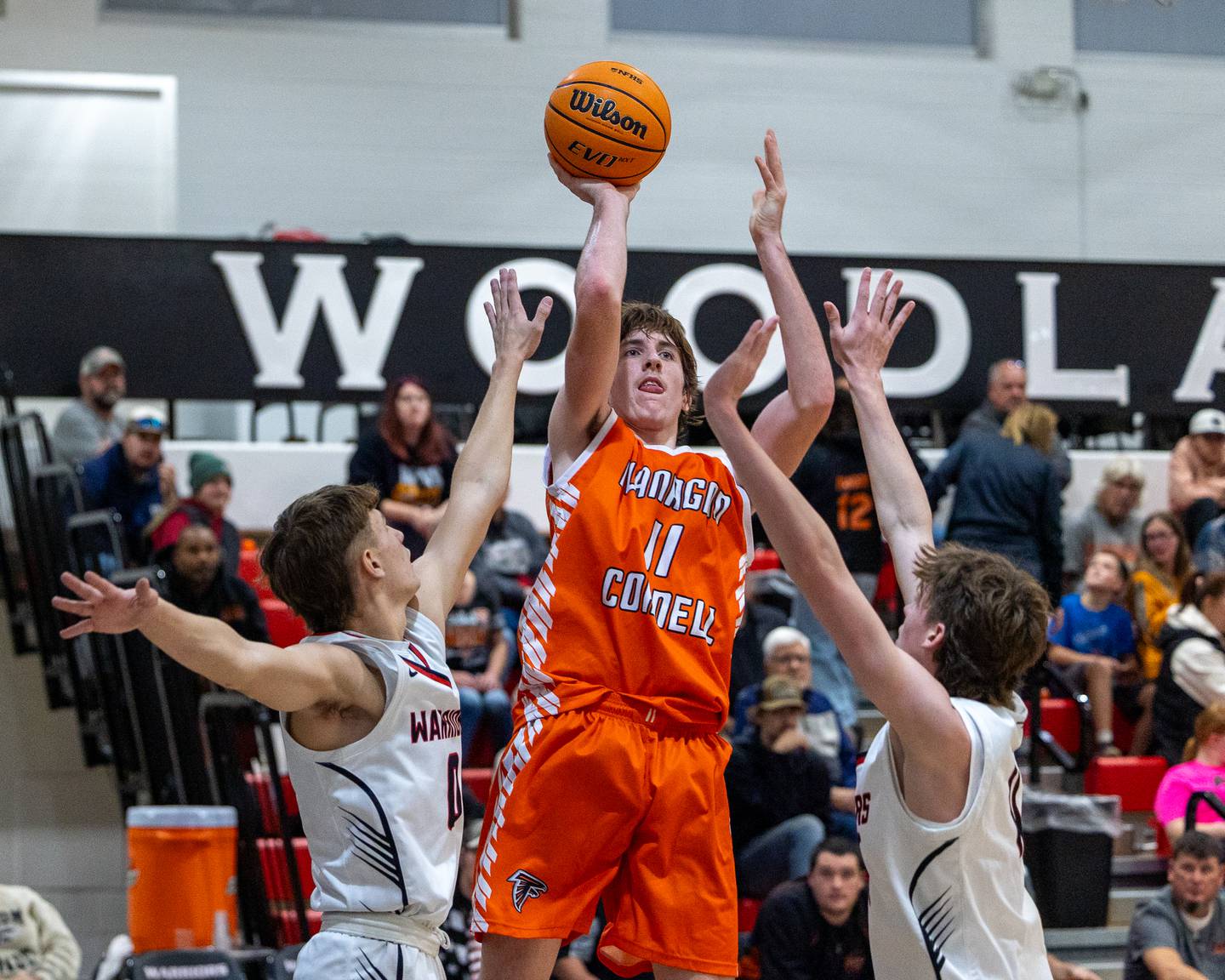 Logan Ruddy (11) of Flanagan-Cornell shoots midrange shot over Woodland's defense in a game earlier this season at Woodland High School in South Streator.