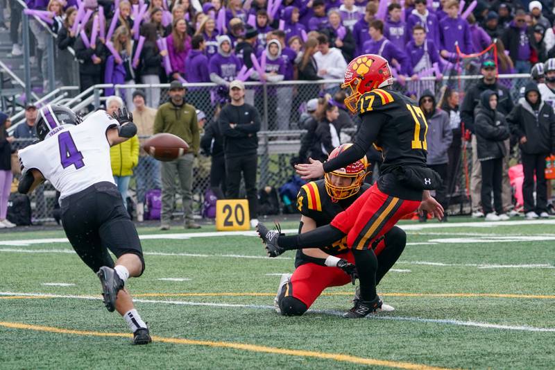Batavia’s Caleb Peters (17) kicks an extra point against Downers Grove North during a class 7A quarterfinal playoff football game at Batavia High School on Saturday, Nov. 16, 2024.