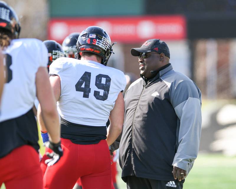 Northern Illinois University head coach Thomas Hammock talks to Brock Lampe (49) during warmups during a spring scrimmage Saturday April 16th held at Huskie Stadium in DeKalb.