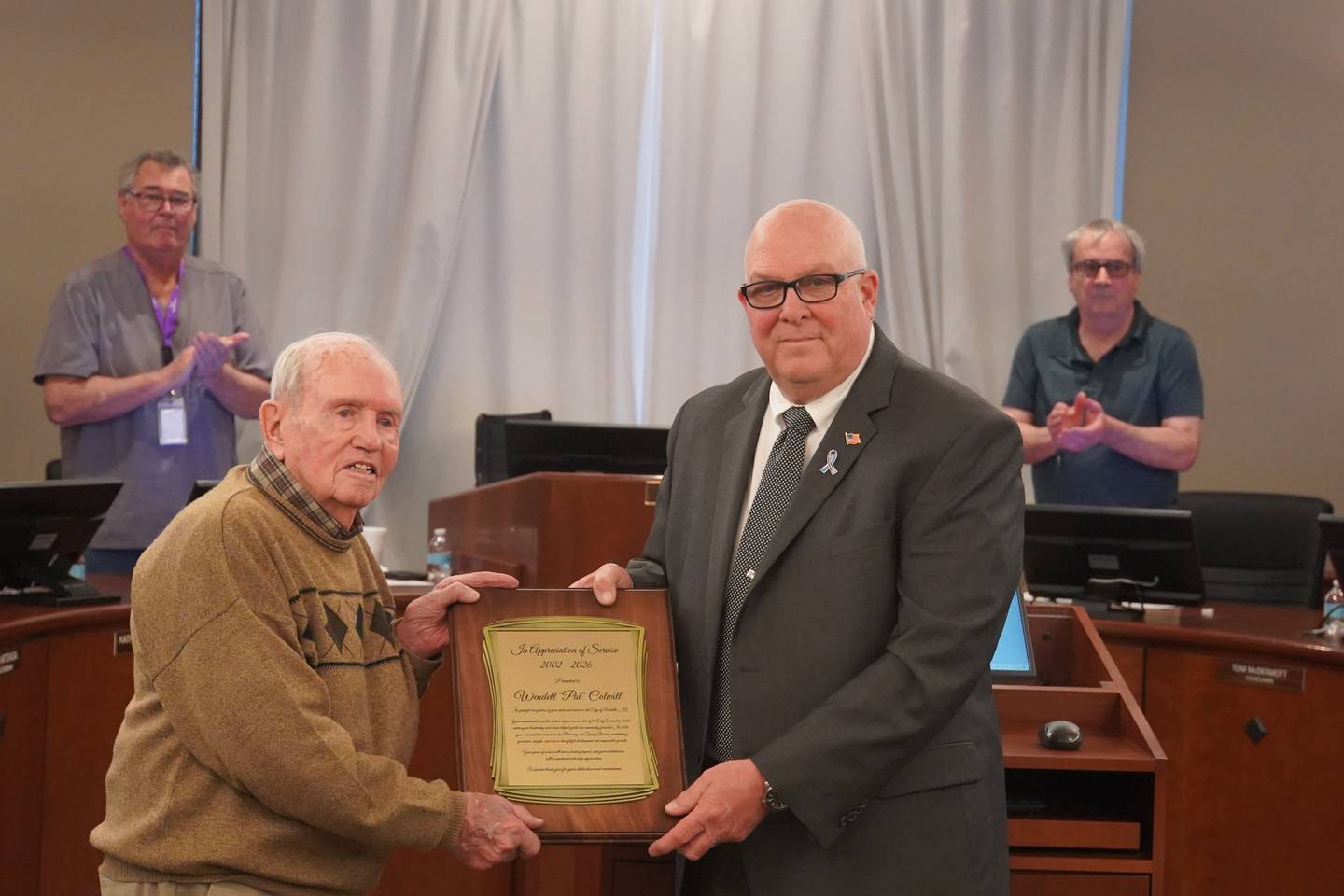 Rochelle Mayor John Bearrows (right) presents a plaque to longtime city planning & zoning commission member Pal Colwill at the Monday, April 13 meeting of the Rochelle city council.