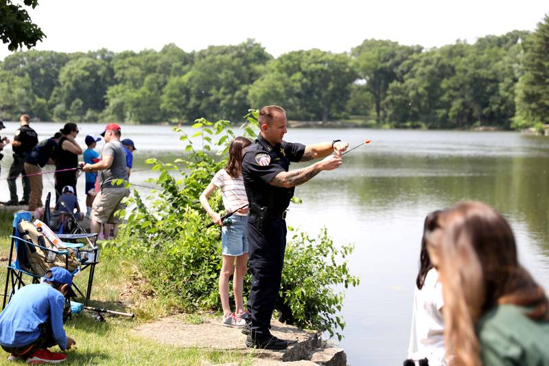 Wheaton Police Department and DuPage County Forest Preserve Police teamed up for the Cops & Bobbers community fishing event at Herrick Lake Forest Preserve in Wheaton on Wednesday, June 7, 2023.