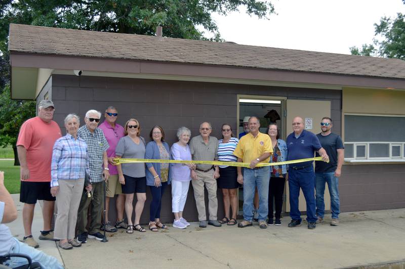Polo city officials and members of the Polo Lions Club and Burkardt family pose for a photo on July 29, 2024, in front of a new concession stand at Millard Deuth Westside Park. Left to right are Alderman Randy Schoon, Rita Jacks, Richard Jacks, Mike Faivre, Paula Burkardt-Faivre, Pam Burkhardt-Ballard, Beverly Burkardt, Bill Burkardt, Patti Burkardt-Brewer, Paul Weimken, Mark Ebert, Pam White, Mayor Doug Knapp and Nathan White.
