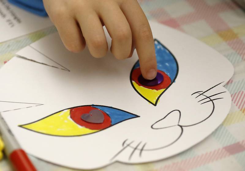 Nora Patnaude, 7, adds eyes to her mask as children make masks on Wednesday, Oct. 23, 2024, during at Kids Crafternoon at the Harvard Diggins Library. Children were able to chose between several Halloween themed masks to make.