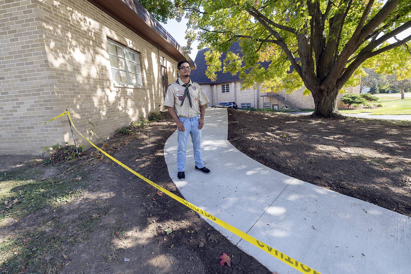 Cruz Ocampo talks about his Eagle Scout project Tuesday, October 8, 2024, outside of Dixon Church of the Brethren. Ocampo and other scouts poured concrete to make a pathway for parishioners.