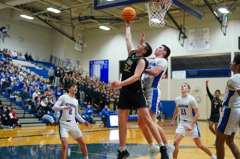 Glenbard North's Matt Welch (32) shoots the ball in the post against Geneva’s Benjamin Peterson (32) during a class 4A Geneva Regional final basketball game at Geneva High School on Friday, Feb. 28, 2025.