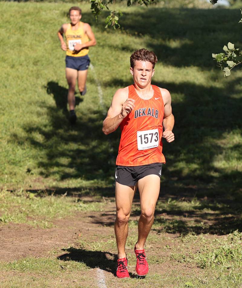 DeKalb's Riley Newport leads the boys race just ahead of Sterling's Dale Johnson Tuesday, Aug. 30, 2022, during the Sycamore Cross Country Invitational at Kishwaukee College in Malta. Newport went on to win the race.