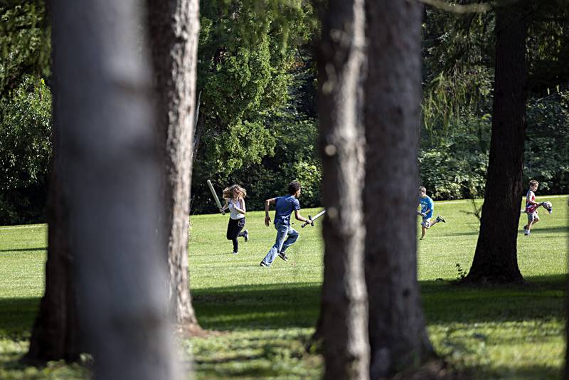 Visitors to Lowell Park’s Fall Fest race around the field with foam swords provided by the CER LARP group Saturday, Sept. 23, 2023. The group meets at the park once a month.