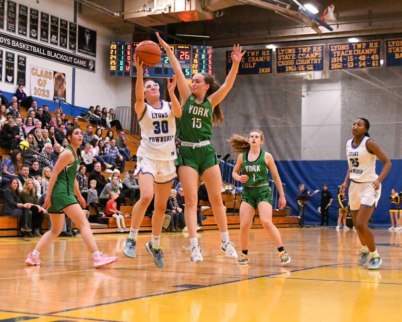 York Allison Sheehan (15) tries to block a shot by Lyons Township Elin O'Brien (30) during the second quarter during the Friday’s Feb. 3rd game held at Lyons Township High School.