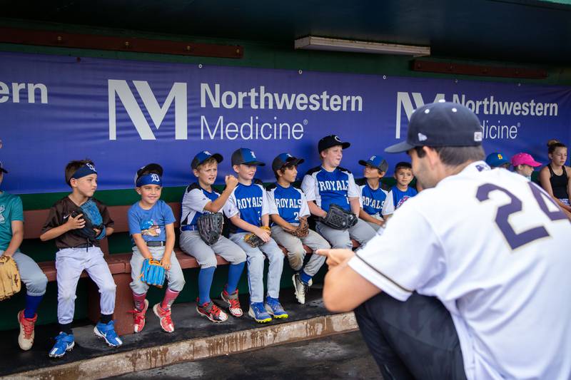 Pitcher Ryan Tapani (24) answers questions from participants at the question and answer station of the Kane County Cougar's Youth Clinic at Northwestern Medicine Field on Saturday, July 16, 2022.