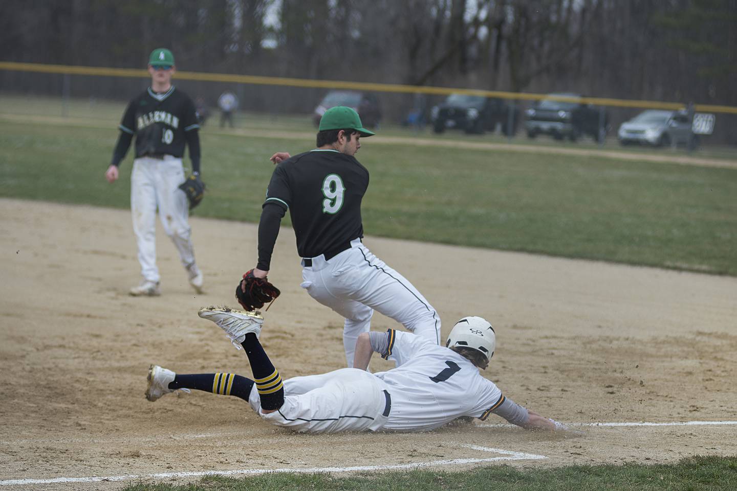 Sterling's Daylen Stage dives in safely at first base to beat out an infield hit Tuesday, April 5, 2022 against Alleman.