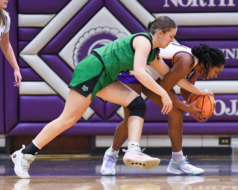 York’s Olivia Silkaitis, left, and Downers Grove North's Elizabeth Murphy, battle for the ball during the game on Tuesday Dec. 3, 2024, held at Downers Grove North High School.
