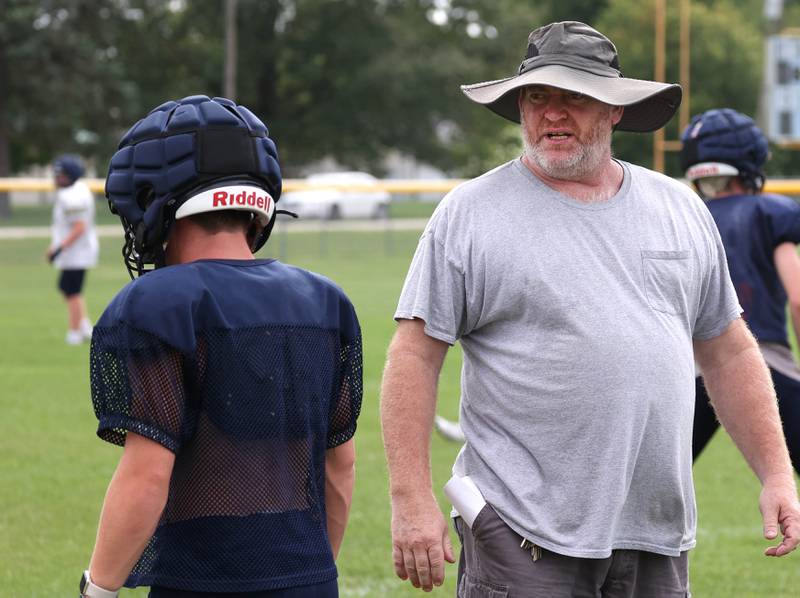 Hiawatha football coach Kenny McPeek talks to a player Tuesday, Aug. 19, 2025, during practice at the school in Kirkland.