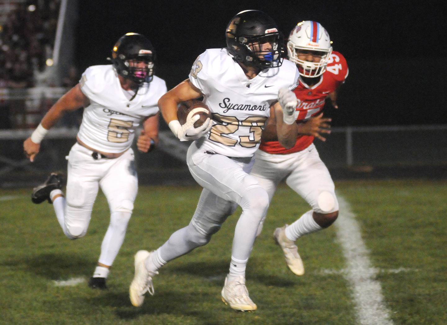 Sycamore's Dylan Hodges outruns Streator's Hector Valdez for a touchdown at King Field on Friday, Sept. 15, 2023.