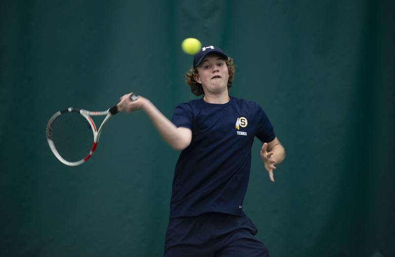 Sterling's Brecken Peterson returns a shot to Rock Island's Joe Brune during a tennis meet at Westwood Thursday, March 31, 2022.