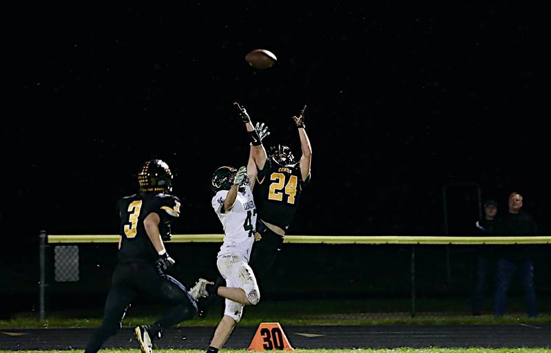 Reed-Custer's Josh Bohac (right) and Coal City's Nolan Berger battle for a pass Friday night in Reed-Custer's 33-9 win.