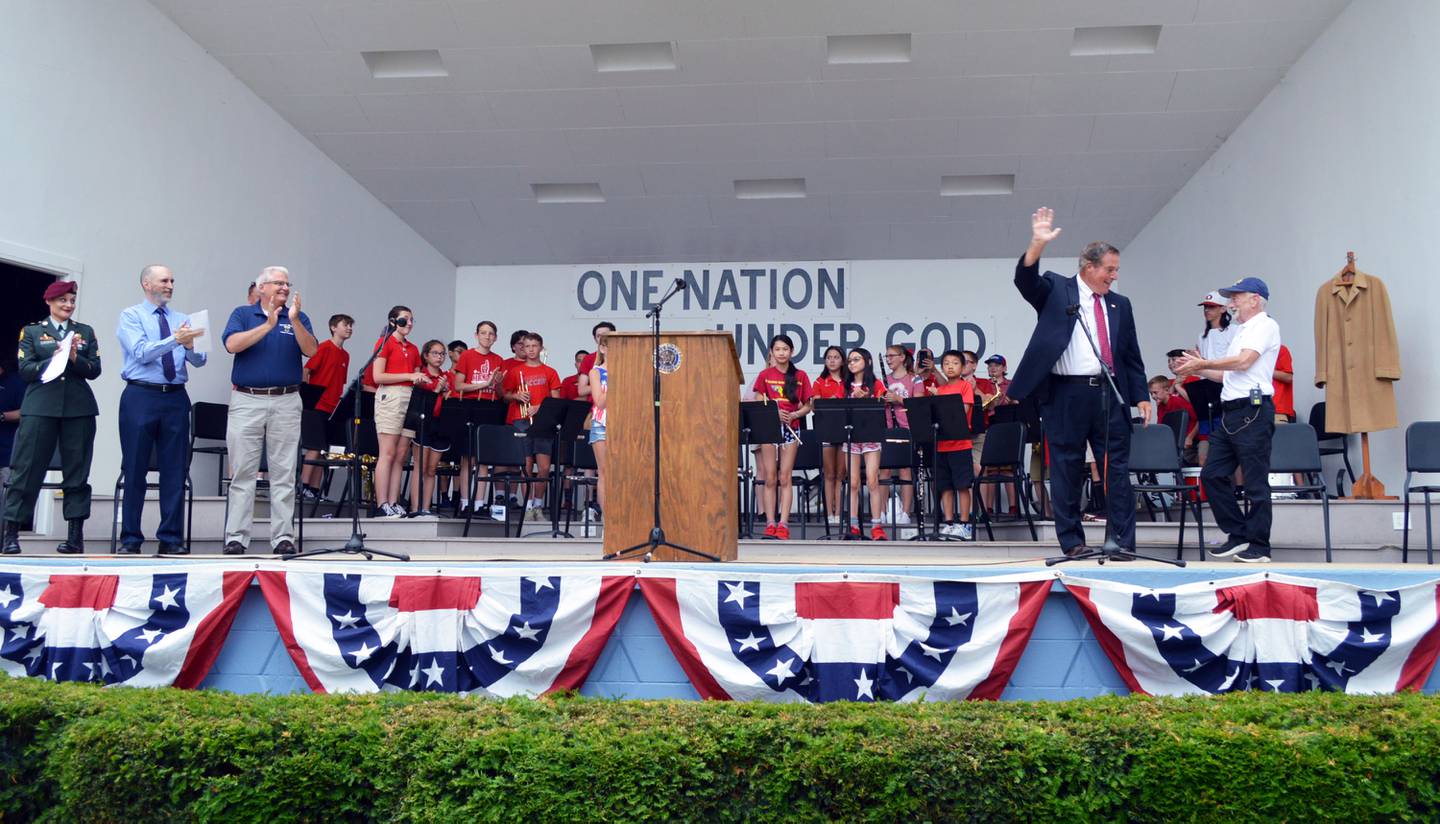 Mark Tremble (second from right), portraying former President Ronald Reagan, waves to attendees of the Let Freedom Ring Patriotic Program on July 4 in Mt. Morris. To Tremble's right is Doug Wean, a U.S. Marine and Vietnam veteran. On the right is Erin Dietrich, a U.S. Army and Afghanistan and Kosovo veteran; the Rev. Bruce McKanna; and Mt. Morris Village President Phil Labash. Reagan visited Mt. Morris in 1963 to dedicate the Illinois Freedom Bell, prior to being elected governor of California or president of the United States.