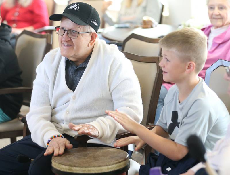 Greenfield resident Edwin Fredericks plays music with Lincoln Elementary School student Tyler Ellberg during a drum circle on Friday, Oct. 17, 2025 at Greenfield Retirement Home in Princeton. The drum circle was hosted by Eric Swanson of Chicago, through his business Drum Impact. The students learned how to make rhythm, play instruments, music therapy, collaboration and converse with the residents.
