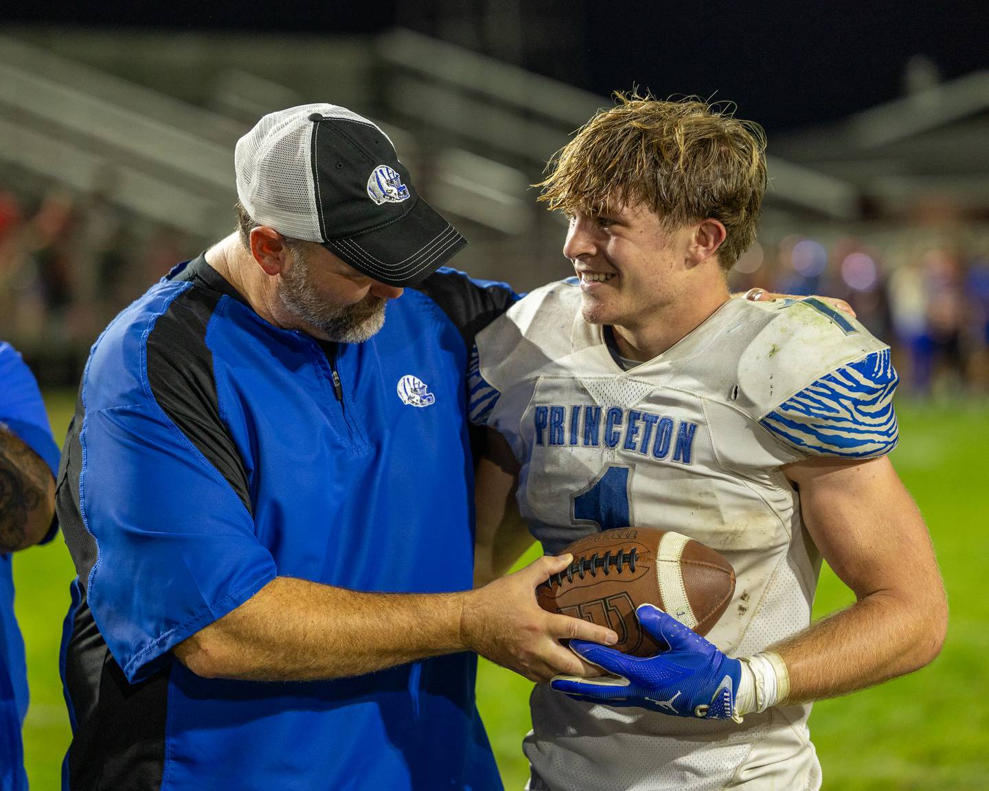 Princeton Head Coach, Ryan Pearson awards game ball to player Casey Etheridge after he becomes the all-time leading rushing yards leader in Bureau County on Friday, Oct. 3, 2025 at Richard Nesti Stadium in Spring Valley.