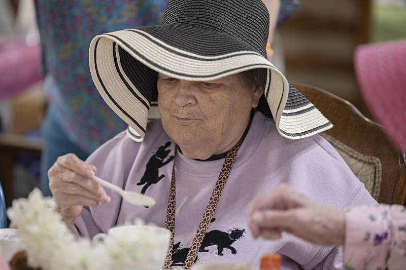 Chery Hannan digs into some ice cream Friday, March 31, 2023. Party honoree Margie Mathias picked the theme, colors and snacks for the tea party.