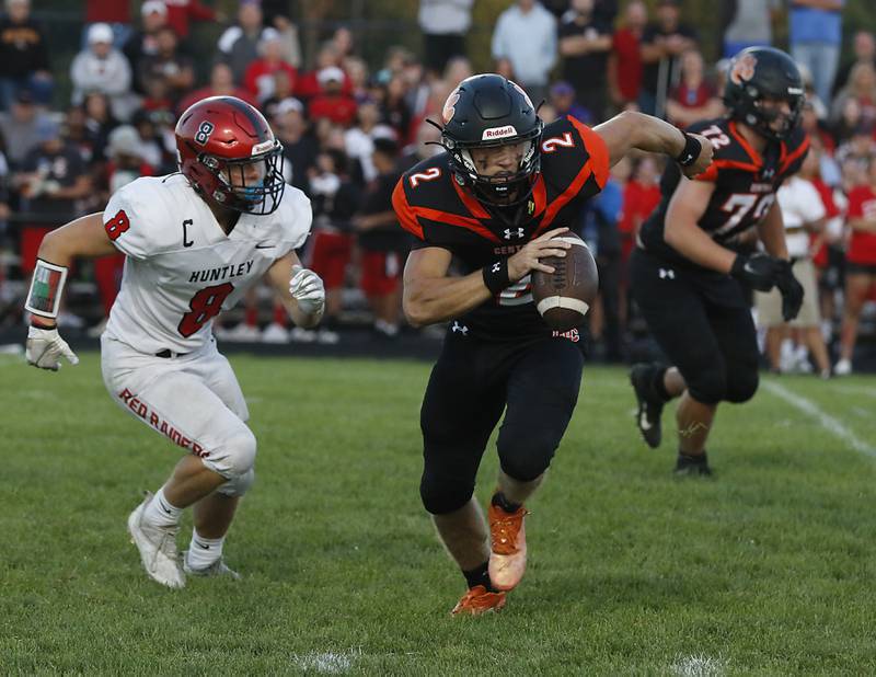 Crystal Lake Central's Jason Penza, right runs away from the pursuit of Huntley's Joey Arvidson during a Fox Valley Conference football game Friday, Aug. 26, 2022, between Crystal Lake Central and Huntley at Crystal Lake Central High School.