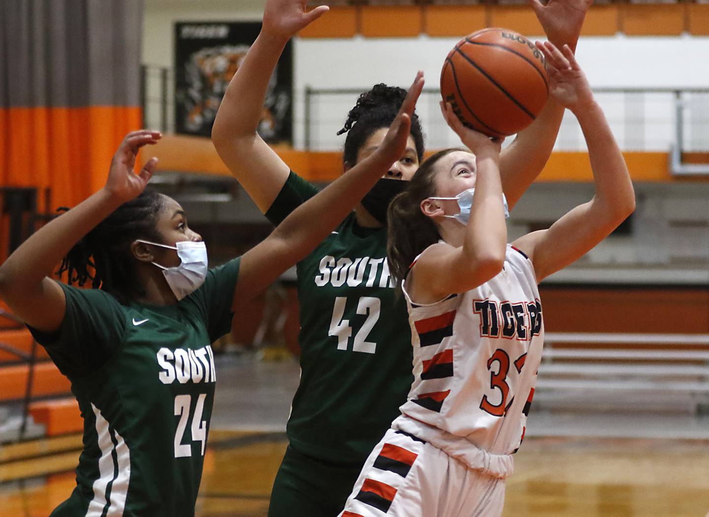 Crystal Lake Central's Kathryn Hamill, right, shoots the ball between Crystal Lake South's Kree Nunnally, left, and Nicole Molgado, center, during a Fox Valley Conference game Wednesday, Jan. 26, 2022, between Crystal Lake South and Crystal Lake Central at Crystal Lake Central High School.