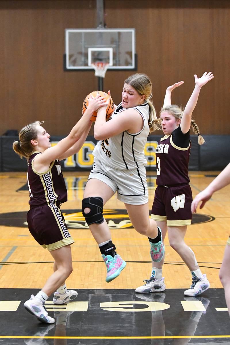 Reed-Custer's Harlie Liebermann attempts to evade Watseka's Kami Muehling, left, during the Warriors' 50-24 victory over Reed-Custer in the IHSA Class 2A Herscher Sectional semifinal on Tuesday, Feb. 25.