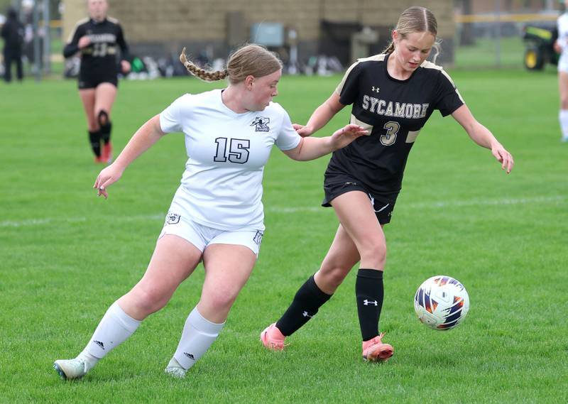 Sycamore's Marin Gautcher kicks the ball away from Kaneland's Maya Heller during their game Wednesday, April 29, 2026, at Sycamore High School.