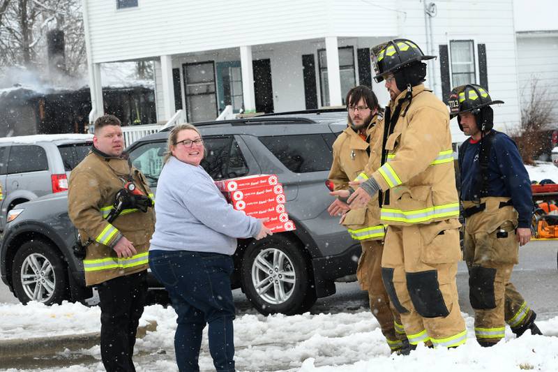 Holly Zumbragel, the manager at Casey's in Byron, delivers doughnuts to firefighters who battled the fire at 115 W. Third Street on Saturday morning.