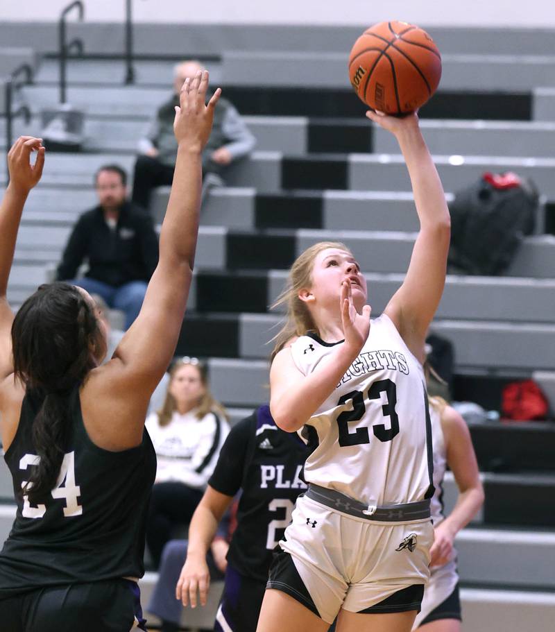 Kaneland’s Kendra Brown scores in front of Plano’s Mikayla Walls during their game Tuesday, Dec. 13, 2022, at Kaneland High School in Maple Park.