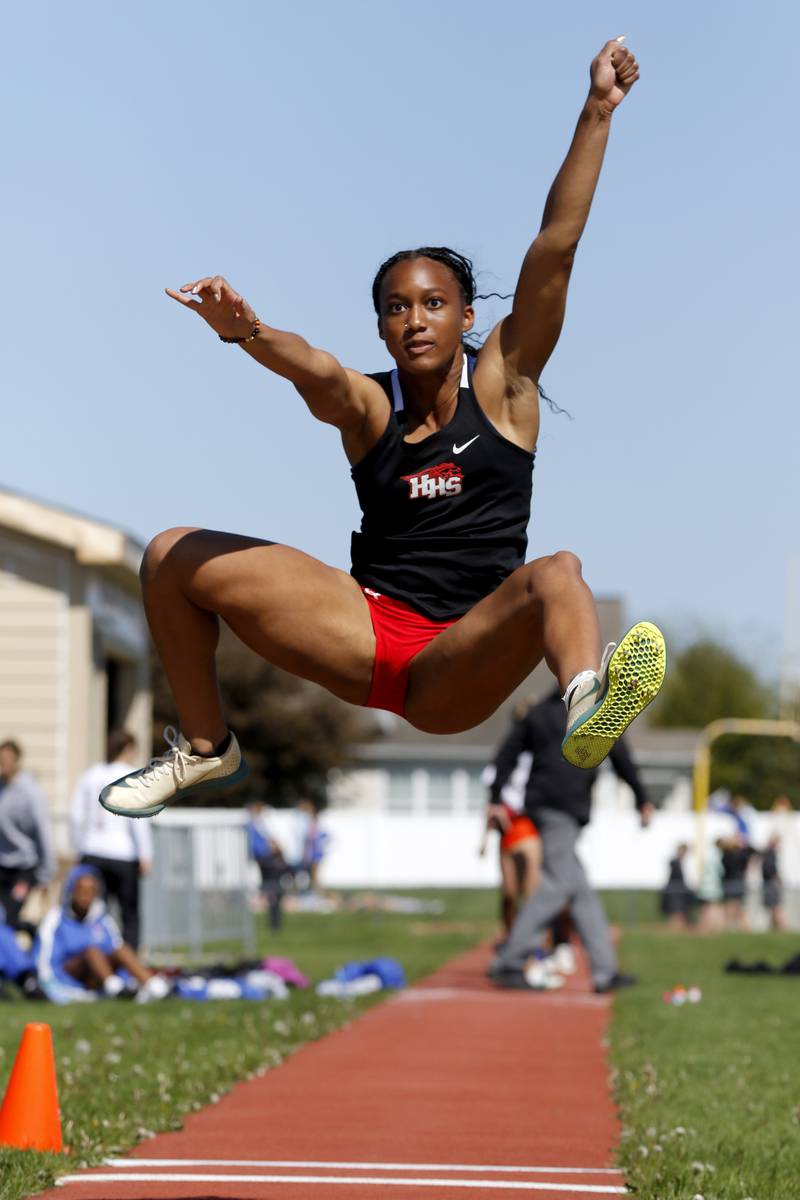 Huntley’s Dominique Johnson long jumps on Thursday, May 8, 2025, during the Fox Valley Conference Girls Track and Field Meet at Huntley High School.