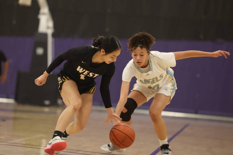 Joliet West’s Christina Keoborakot gets the steal on a pass to Joliet Catholic’s DeAnna Cooley in the 2023 WJOL Girls Basketball Tournament on Friday, Nov. 17, 2023, in Joliet