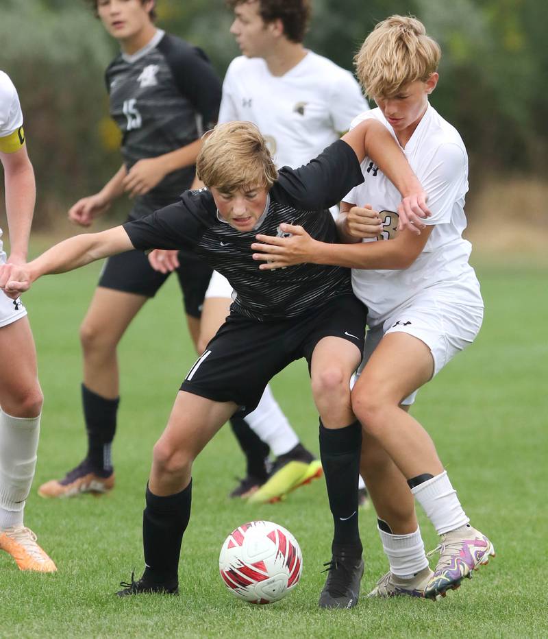 Kaneland's Matthew Mitchinson (left) and Sycamore's Gavin Crouch try to gain possession during their game Wednesday, Sept. 6, 2023, at Kaneland High School in Maple Park.