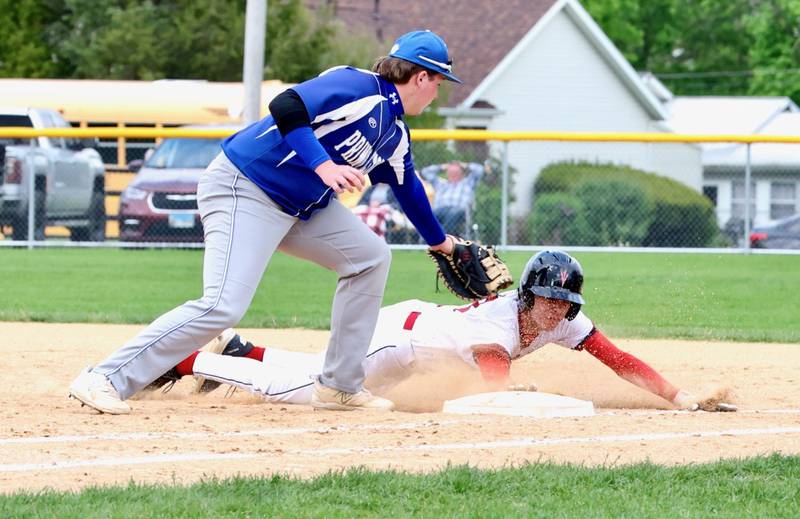 Hall's Braden Curran slides back in safely on a pickoff throw to Princeton first baseman Monday at Prather Field. Hall won 10-4.