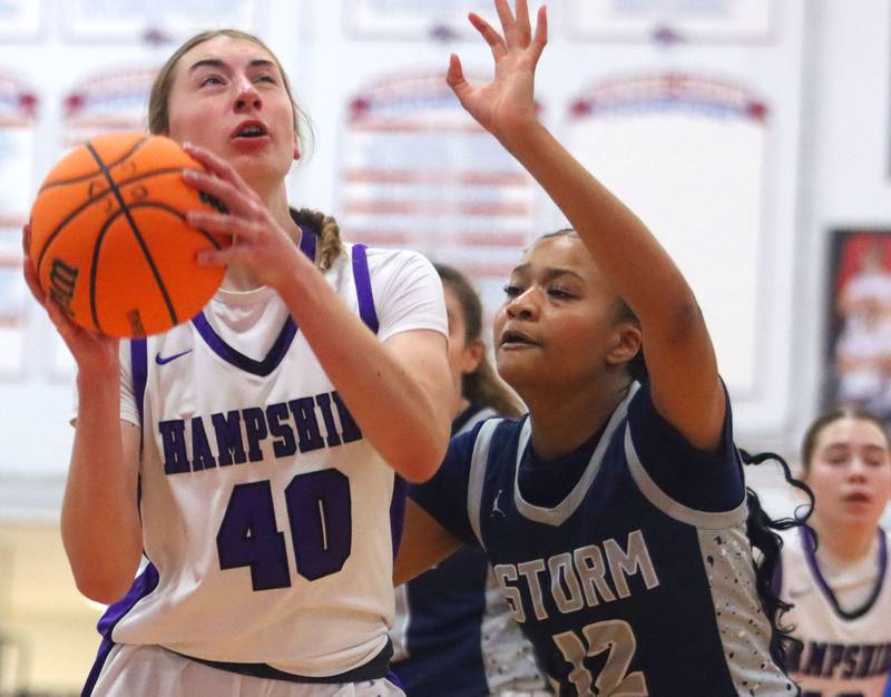 Hampshire’s Aubrey Fudala, left, looks for the hoop as South Elgin’s Hope Nelons, right, defends in varsity girls basketball Komaromy Classic tournament  action on Monday, Dec. 29, 2025, at Dundee-Crown High School in Carpentersville.