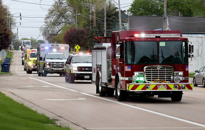 An escort, including Hinckley and Big Rock first responders, leads Marshall Morong, 7, a first grader at Hinckley-Big Rock Elementary School Monday, down Lincoln Avenue Monday, May 5, 2025, on his way for his first day back following months waiting for, and eventually receiving, heart transplant surgery at Lurie Children’s Hospital of Chicago. Morong arrived in style in a Tesla Cybertruck donated for use by Telsa of Naperville.