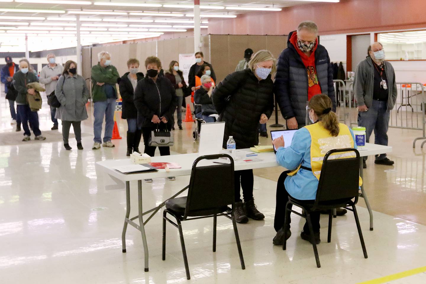 Absil and Karl Marceline of Cary check in Tuesday, March 2, 2021, at the McHenry County Department of Health COVID-19 vaccination clinic at 1900 N. Richmond Road, the former site of a Kmart in McHenry.  Vaccinations are made by appointment only.