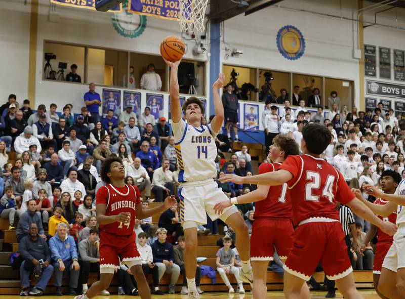 Lyons Township's Grant Smith (14) puts up a shot during a varsity basketball game between Hinsdale Central and Lyons Township high schools on Friday, Dec. 12, 2025 in La Grange.