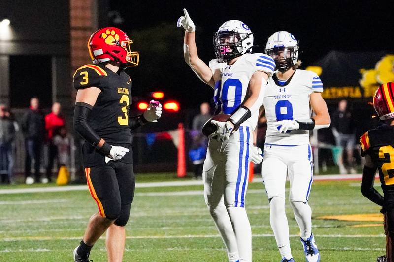 Geneva’s Bennett Konkey (80) points up at the score board after catching a pass for a first down against Batavia during a football game at Batavia High School.