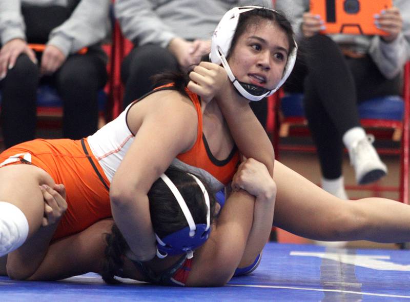 McHenry’s Natalie Corona, top, battles Dundee-Crown’s Daniella Ibanez in a 145-pound bout in varsity girls wrestling at Carpentersville Thursday night.