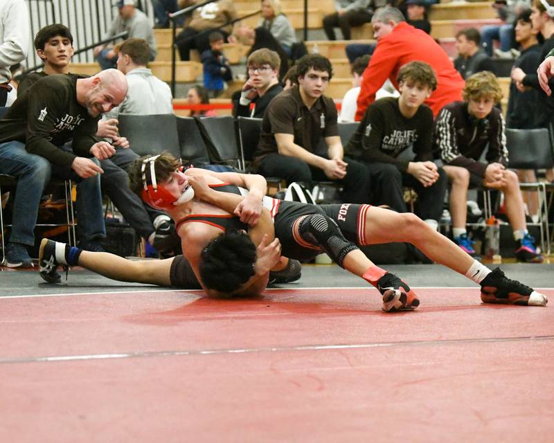 Ramsey Barton of Yorkville, top, pins  Jon Higueros of Joliet Catholic Academy during the 106-weight class during the regional meet on Tuesday Feb. 25, 2025, held at Yorkville High School.